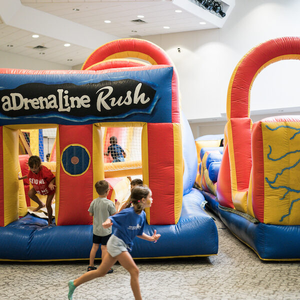 Due to temperatures in Fort Worth topping 100 degrees for the 19th consecutive day on Aug. 11, the Church Fair and Block Party was moved indoors to the Riley Center where children enjoyed bounce houses in an air conditioned room.